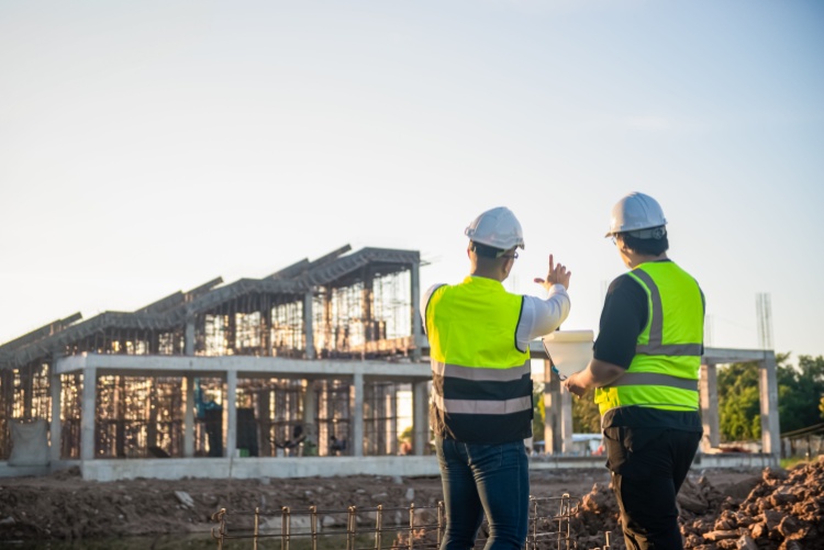 two construction workers survey their jobsite